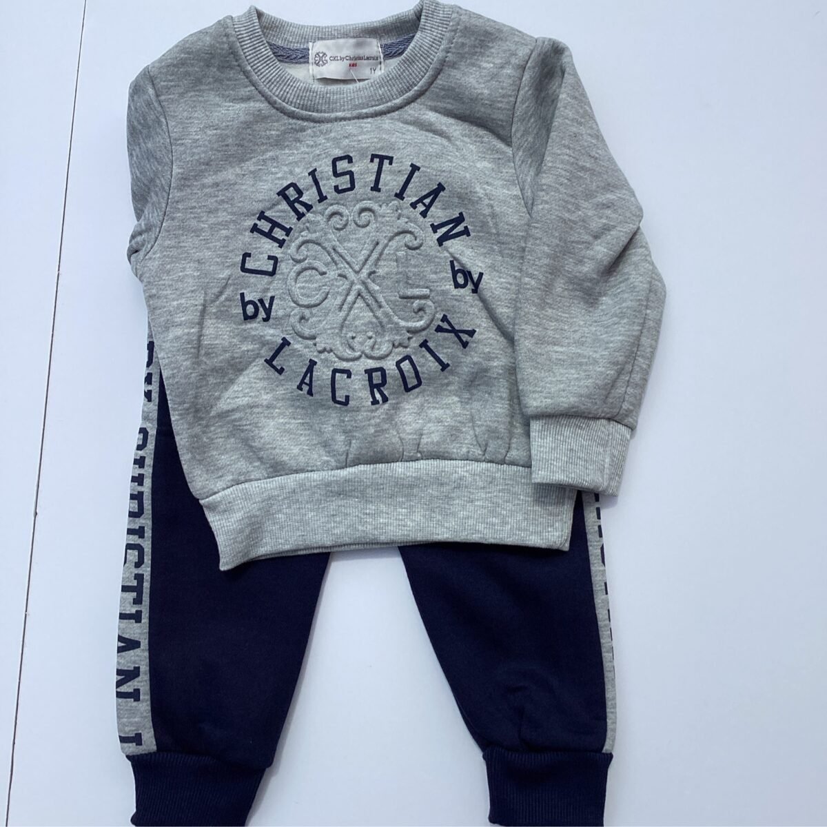 Elevate your boy's style with the Grey Lacroix Tracksuit 2 piece. This comfortable and versatile outfit boasts a stylish design that's perfect for any occasion.