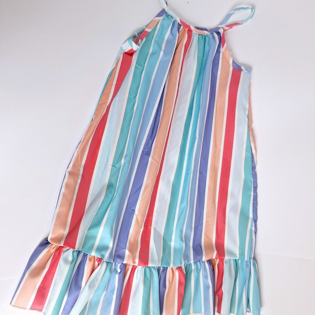 Step into style with our candy-colored striped dress, showcasing vibrant colors and a flattering silhouette. Embrace the fun and chic look with this must-have piece for your wardrobe.