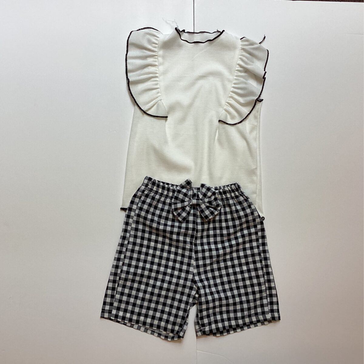 Elevate your style with this chic black and white top and short set. Its versatile monochrome design and comfortable fit make it perfect for creating effortless mix-and-match outfits.