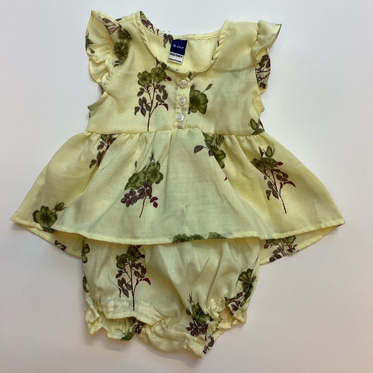 Dress your little one in style with this yellow floral dress featuring adorable knickers. The vibrant floral design makes it the perfect choice for baby girls. Add this charming outfit to your cart today!