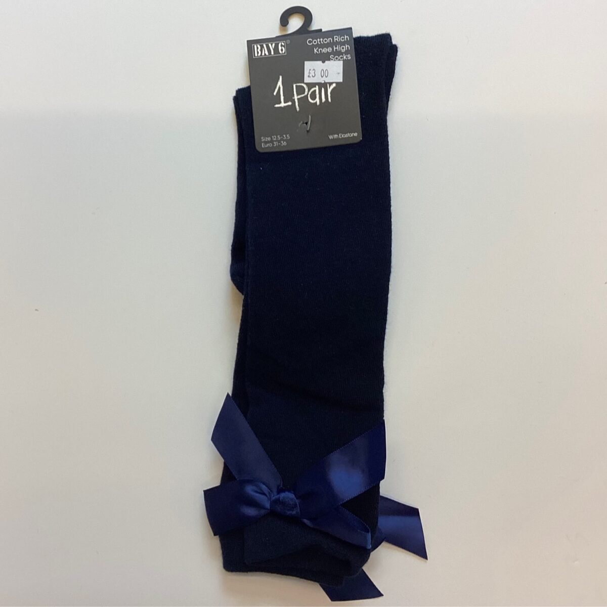 Elevate your little girl's outfit with these Navy Bow Knee High socks, featuring an adorable design and a comfortable fit for all-day wear. Versatile in style, these socks are a must-have addition to her wardrobe.