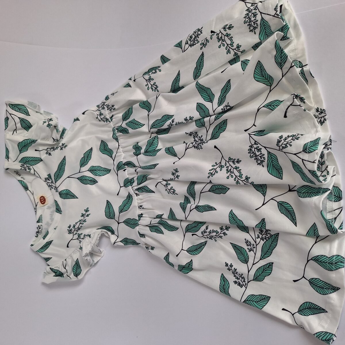 Elevate your wardrobe with this stunning white dress featuring a vibrant green leaf pattern. With its fresh color combination and versatile style, this dress is perfect for any occasion. Add it to your cart now and stand out in floral elegance!