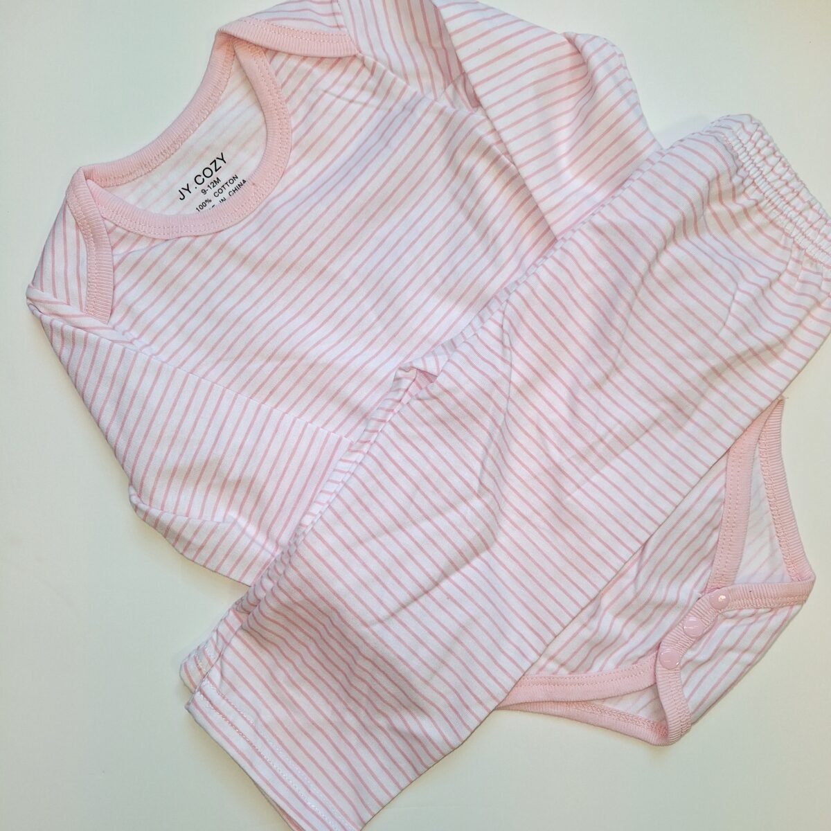 Elevate your wardrobe with this stylish Pink Thin Striped Bodysuit. With a comfortable fit and versatile design, this 2pc long sleeve bodysuit is a must-have for any fashion-forward individual.