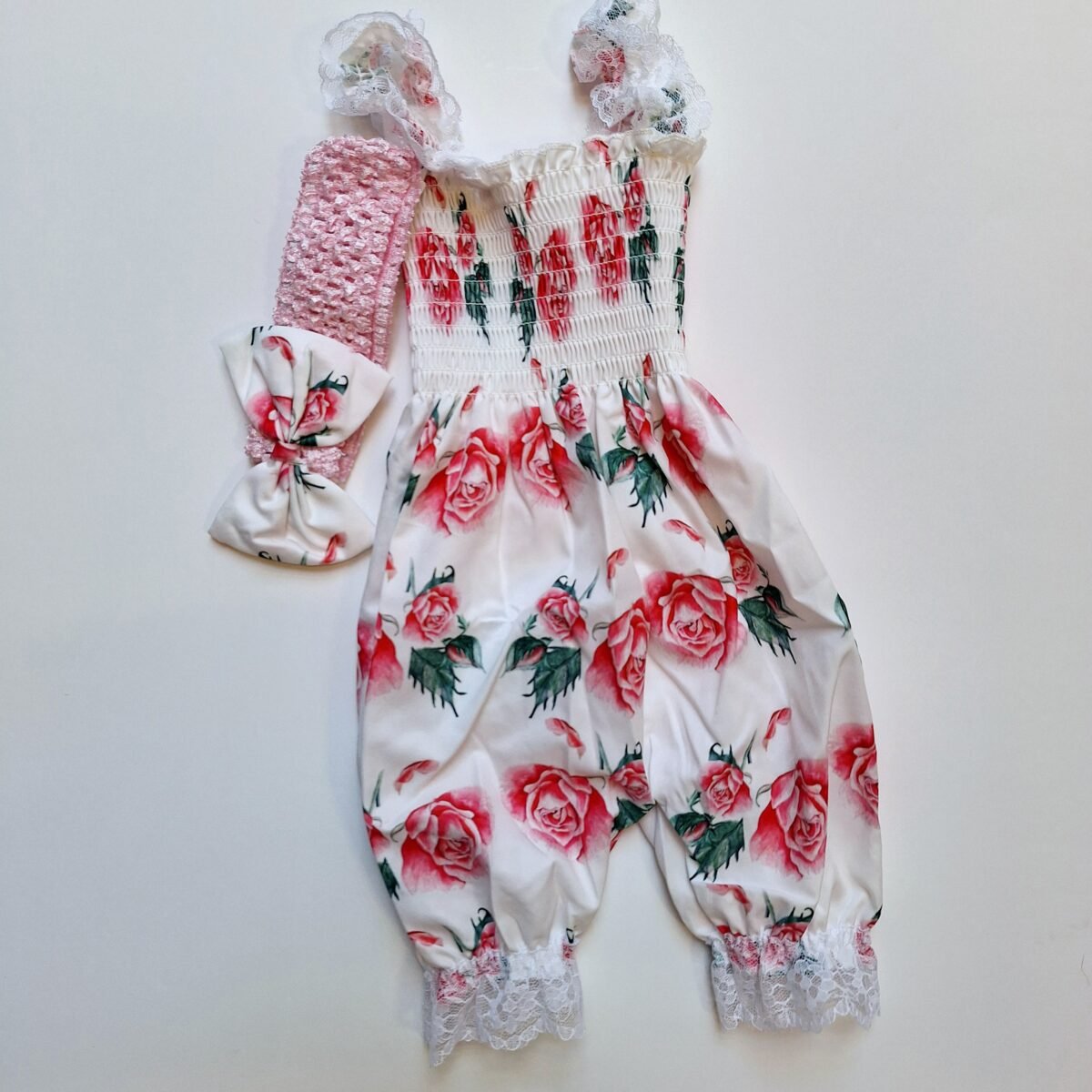 Dress your little one in style with this adorable floral romper made from comfortable 100% polyester. Complete with lace straps and a matching headband, it's the perfect outfit for any occasion!